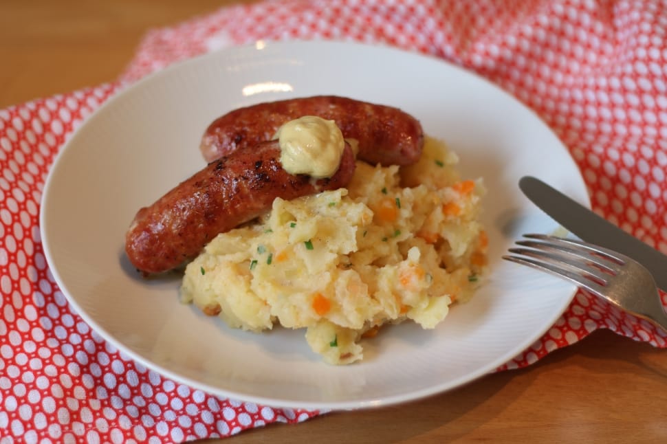 mashed potato and sausages served on white ceramic plate preview