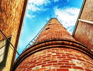 low angle photo of brown brick tower thumbnail