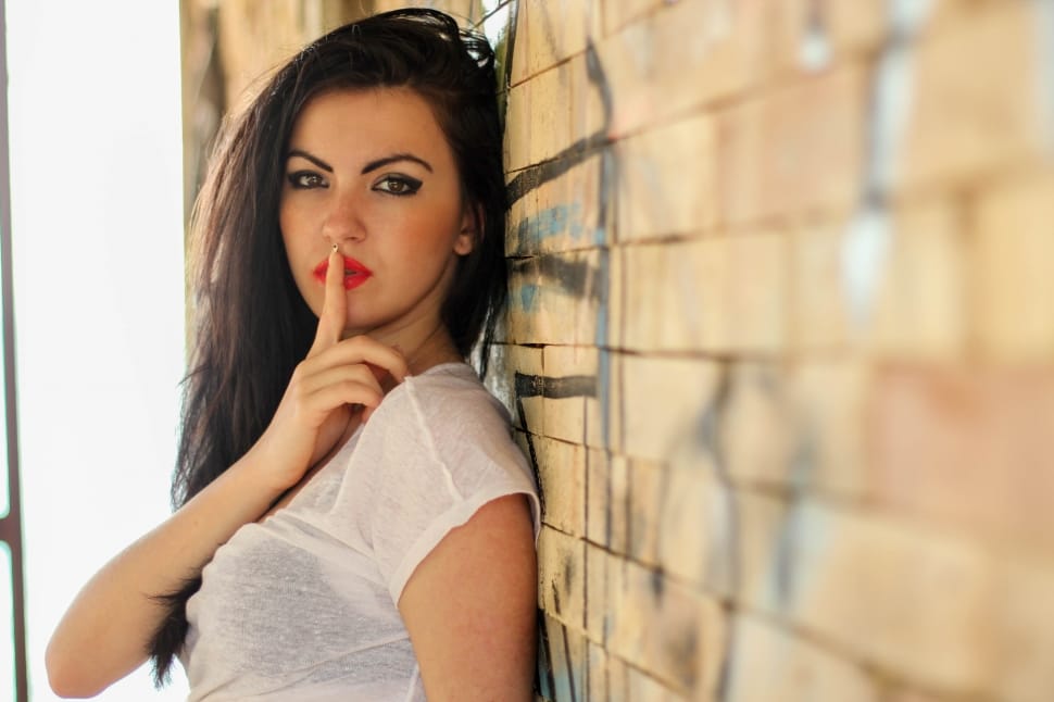 woman doing sshh sign wearing white sheer cap sleeve shirt free image - Peakpx