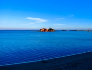 house on an island during daytime thumbnail