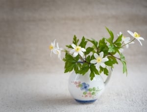 white petaled flowers and white ceramic vase thumbnail