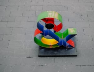 blue, green, and red freestanding ampersand on concrete surface thumbnail