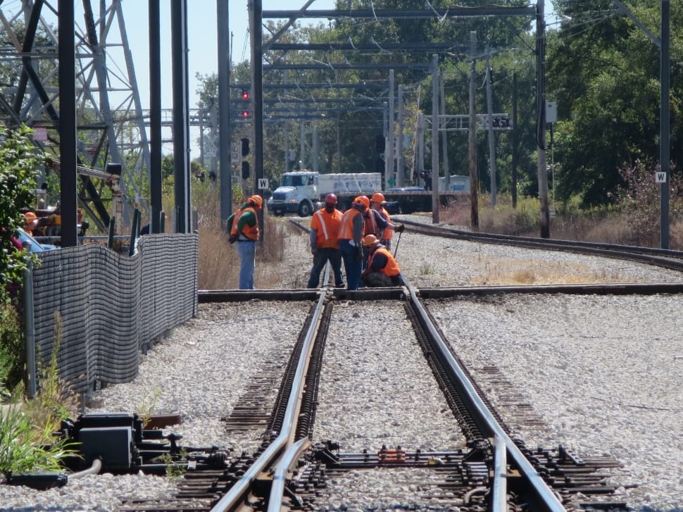 five men working in group on fixing train tracks preview