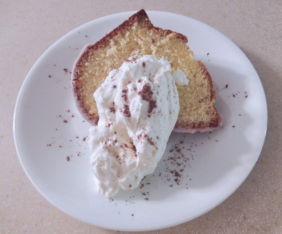 slice bread with cream on white ceramic round plate preview