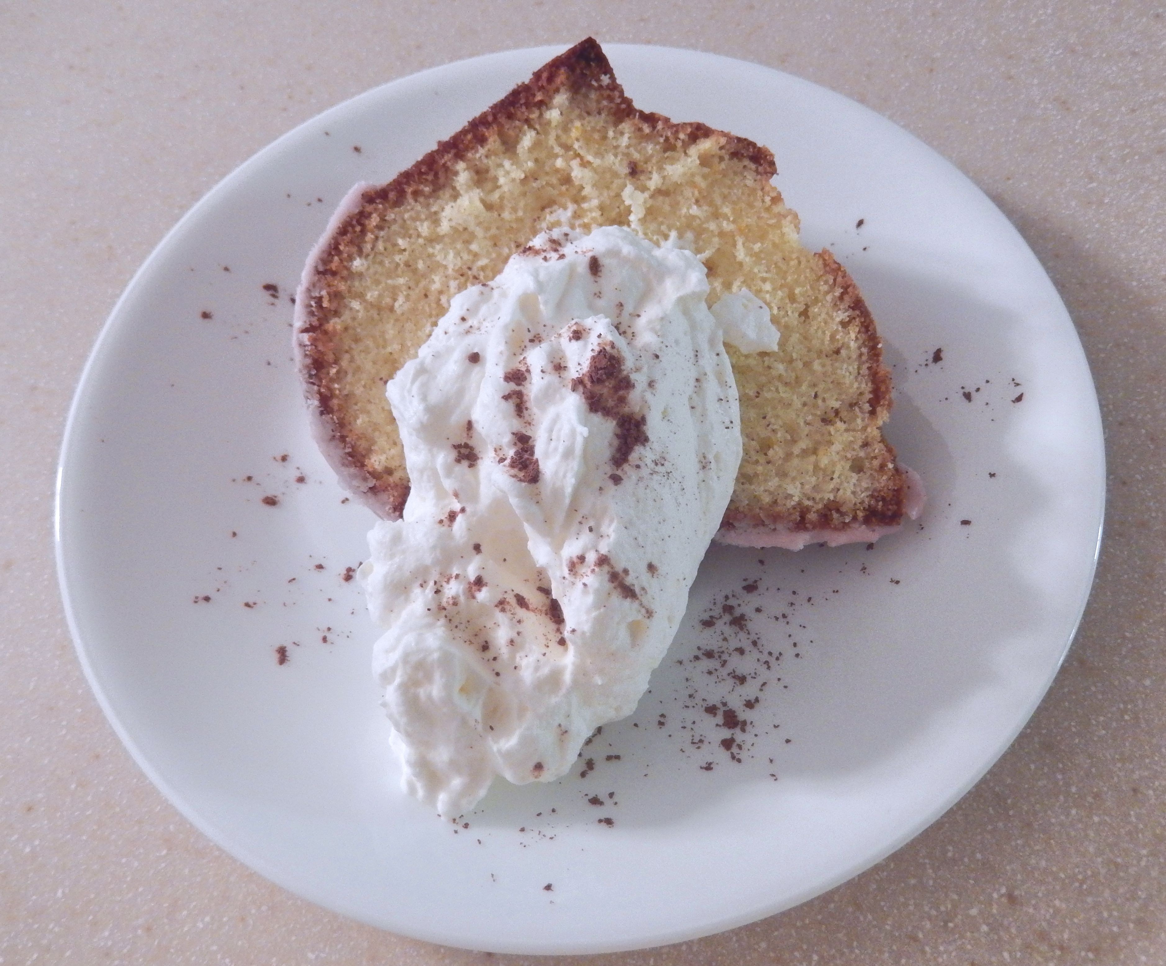 slice bread with cream on white ceramic round plate