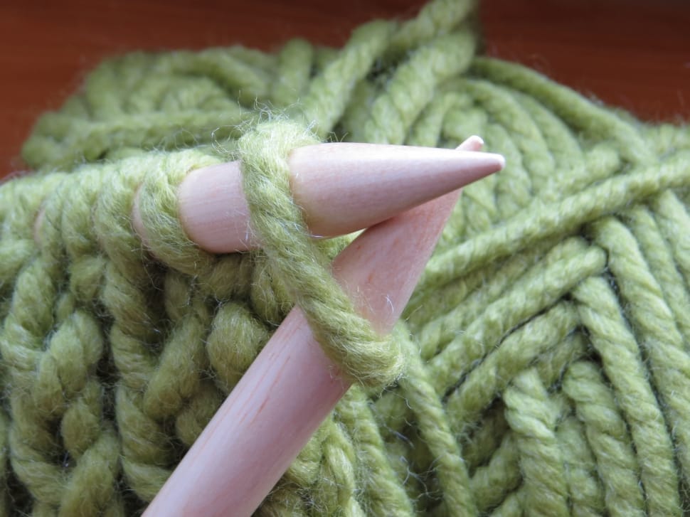 green yarn and pair of wooden stick preview