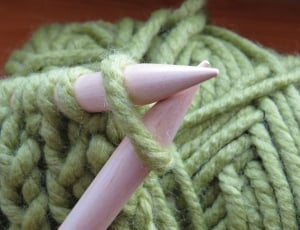 green yarn and pair of wooden stick thumbnail