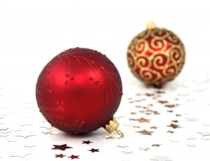 two red and gold-colored decorative balls thumbnail