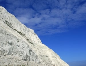 photograph of gray rock cliff during daytime thumbnail
