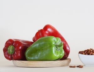 three bell peppers on brown wooden slob thumbnail