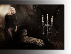woman in black lace long sleeve shirt standing near leopard photo thumbnail