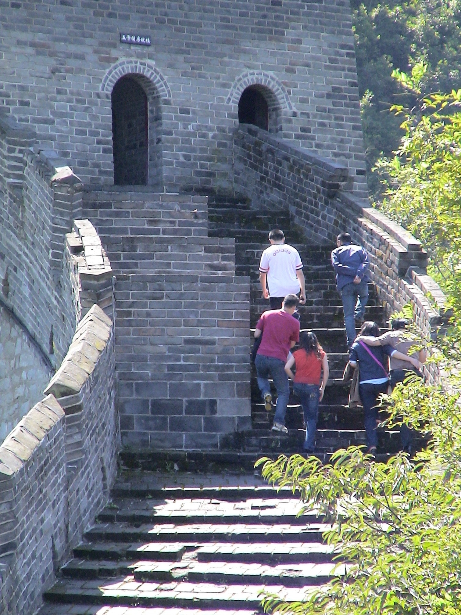 six people climbing up stairs of Great Wall of China at daytime