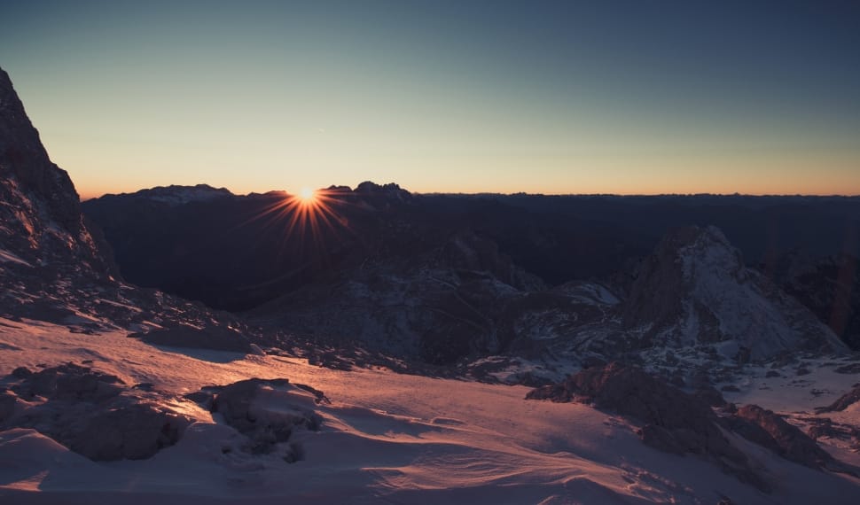 snow covered mountain range in sunset preview