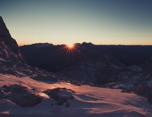 snow covered mountain range in sunset thumbnail