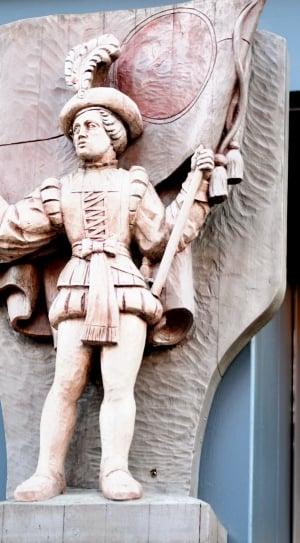 brown statue holding a flag thumbnail