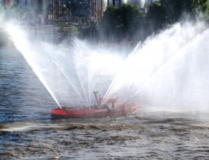red boat spraying water thumbnail