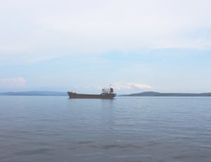 black fishing vessel on ocean at daytime thumbnail