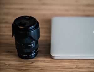 black camera lens and silver macbook thumbnail