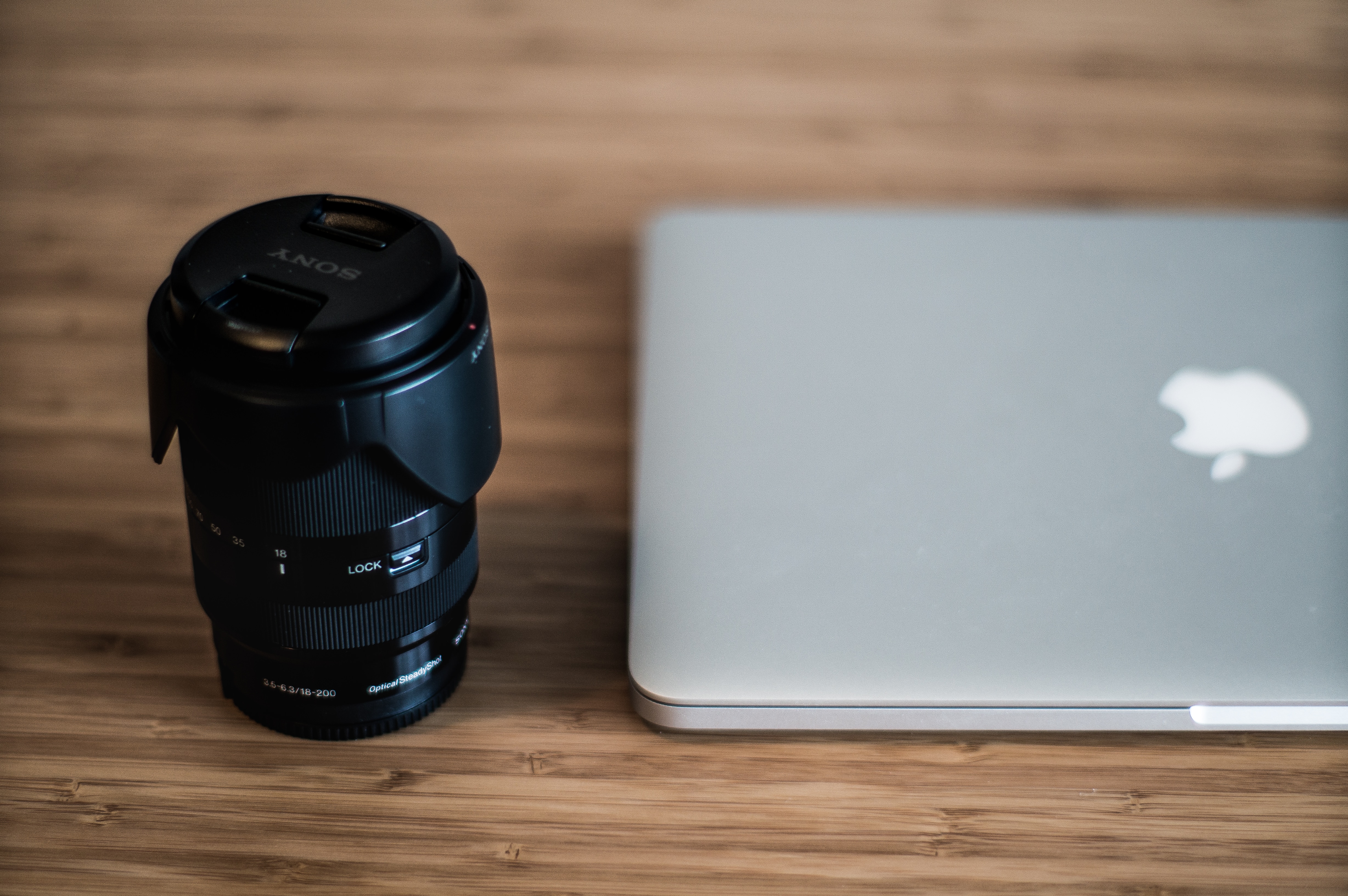 black camera lens and silver macbook