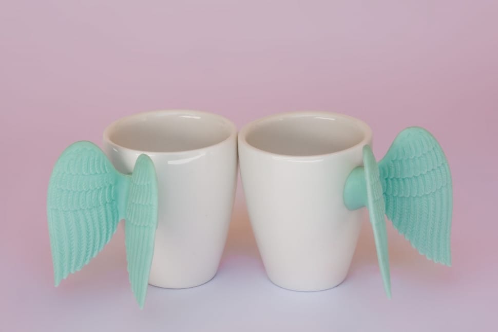 white ceramic with teal wings cup preview