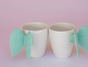 white ceramic with teal wings cup thumbnail