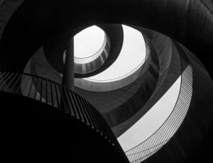 gray scale photography of spiral stair thumbnail