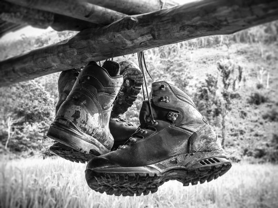 grayscale photo of 2 leather work boots preview