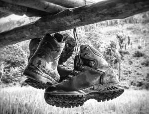 grayscale photo of 2 leather work boots thumbnail