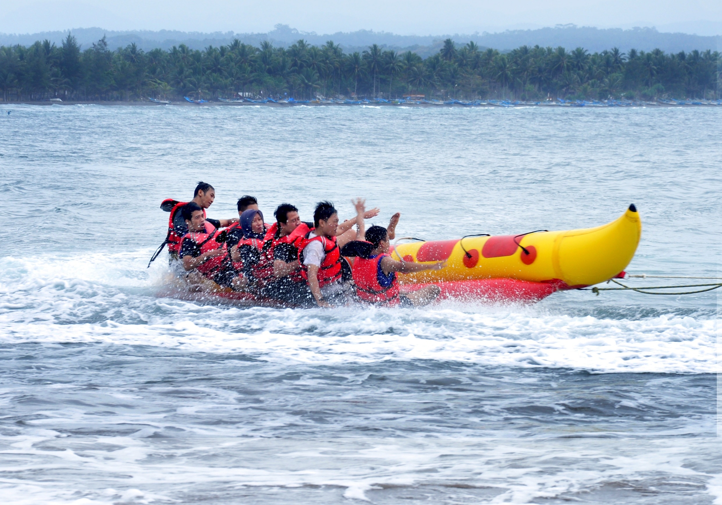 people riding on banana boat during daytime
