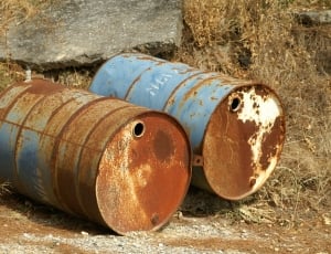 two blue and brown metal barrels thumbnail