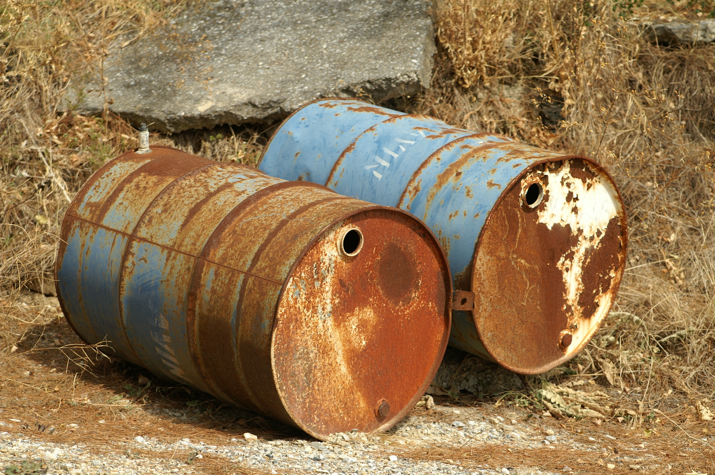 two blue and brown metal barrels
