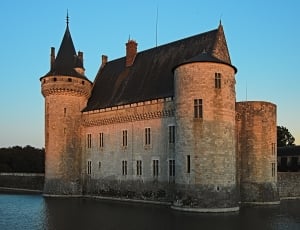 castle with river outer area under calm sky thumbnail