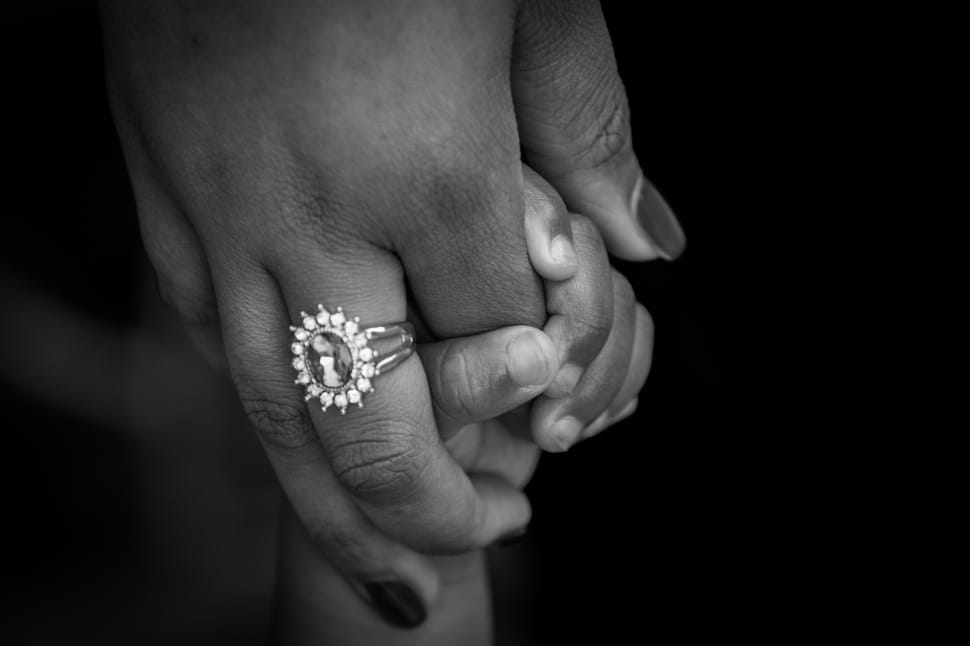 mother with silver diamond rimg holding baby's hand preview