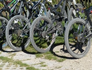 black full suspension bikes parked outside during daytime thumbnail