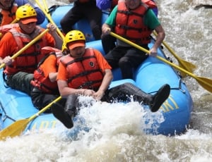 group of person riding on blue inflatable raft thumbnail