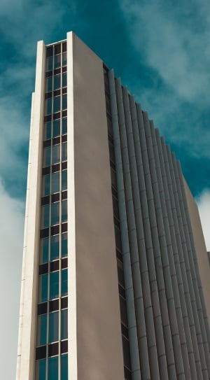 white and gray concrete building in low angle photography thumbnail