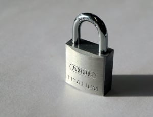 close photo of  Ahue padlock on gray surface thumbnail