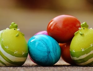 two green plastic cat besides red and blue easter eggs thumbnail