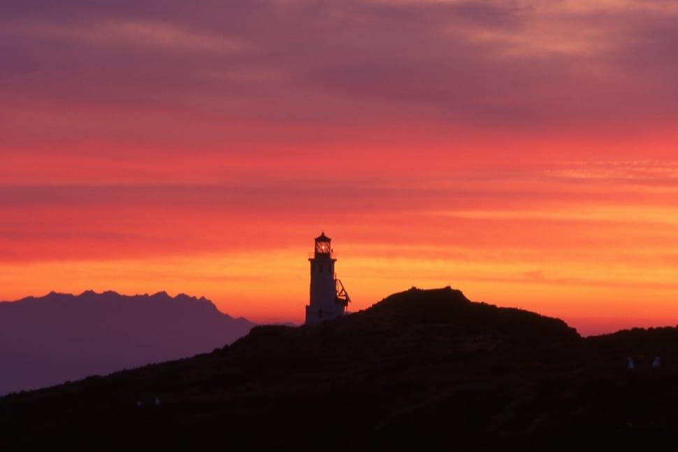 silhouette of ligthouse tower at sunset preview