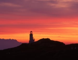 silhouette of ligthouse tower at sunset thumbnail