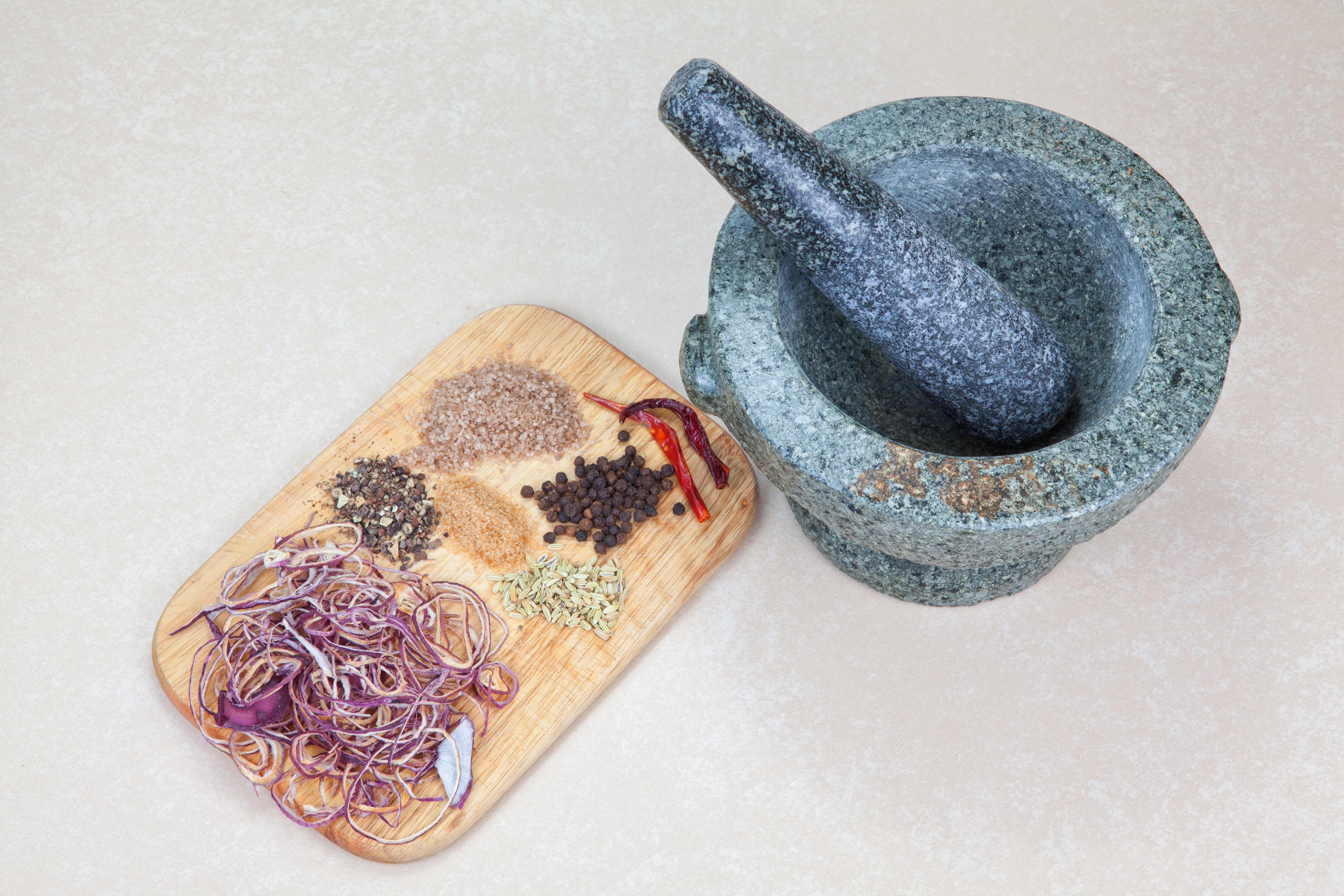gray mortar and pestle and chopping board