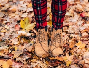 person wearing brown booties on dried leaves thumbnail