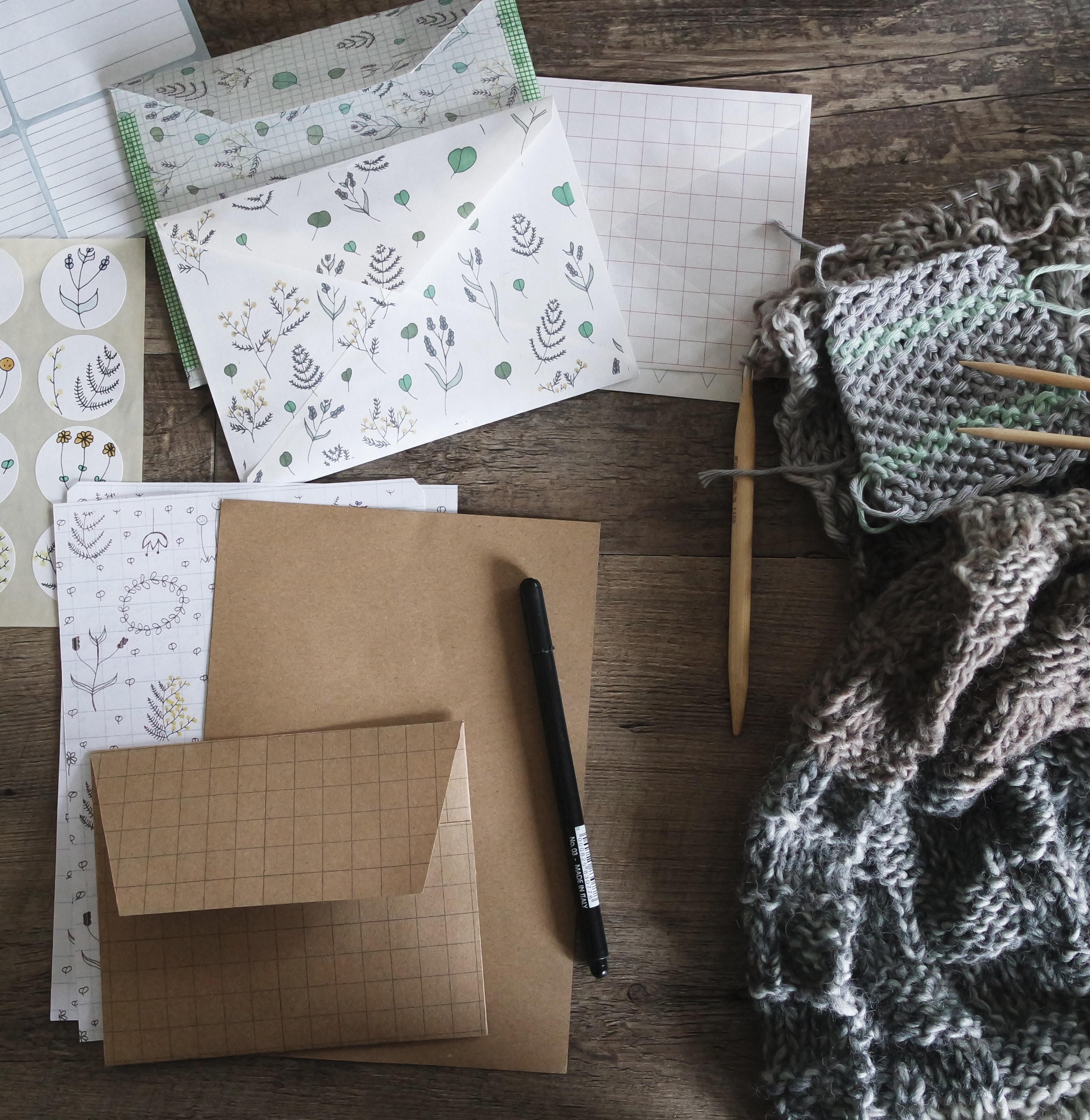 papers, pens, and crochet textile