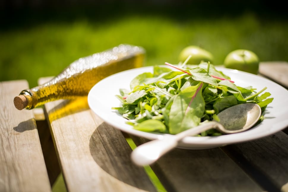 green salad with olive oil bottle preview