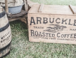 arbuckles trade mark roasted coffees box on green grass field thumbnail