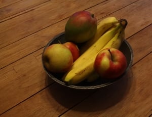 4 red apples and 4 bananas on black bowl thumbnail