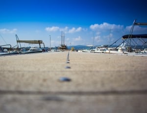 yacht parked in brown concrete dock during daytime thumbnail