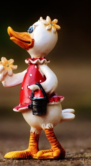 white duck wearing red dress figurine thumbnail