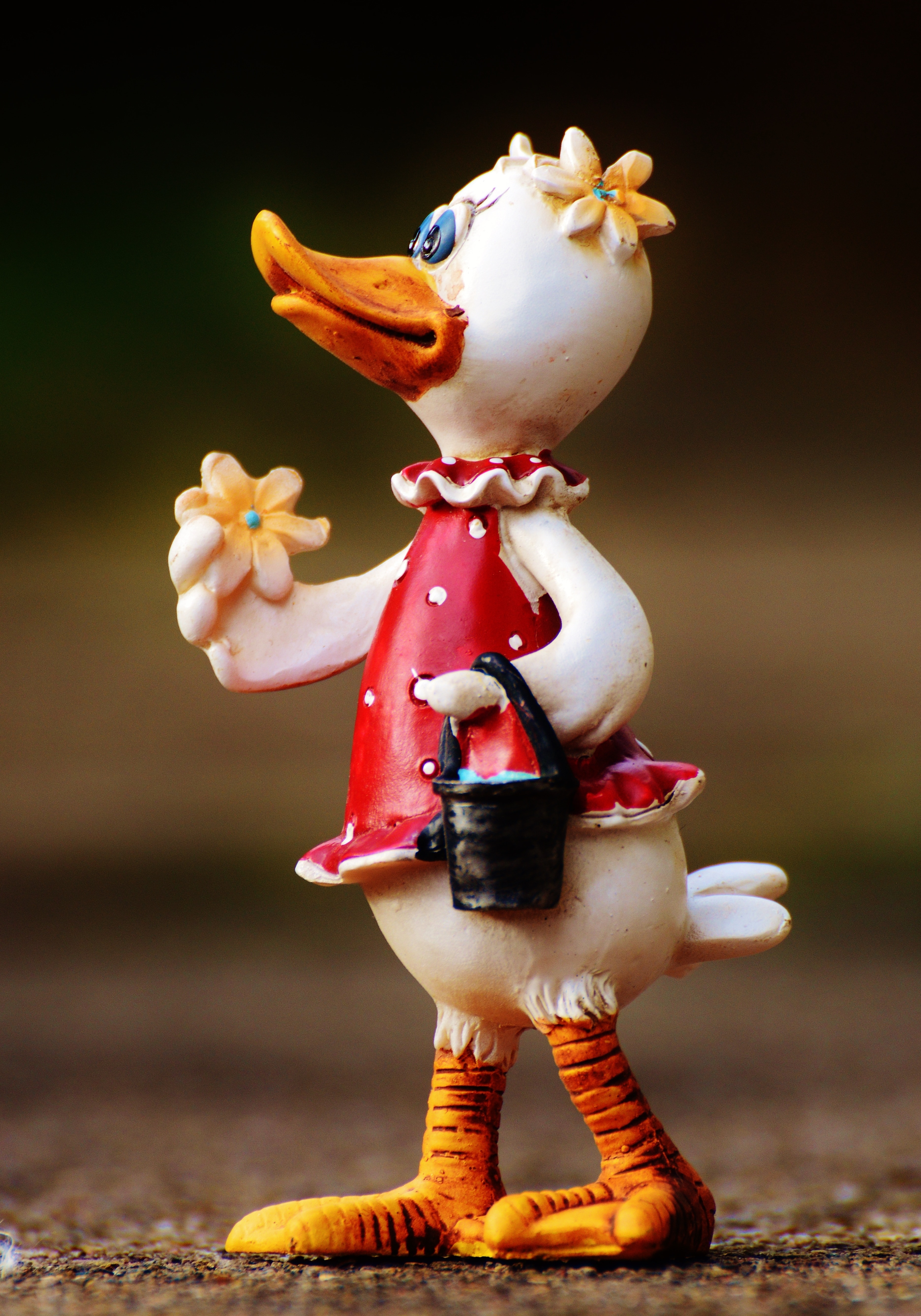 white duck wearing red dress figurine