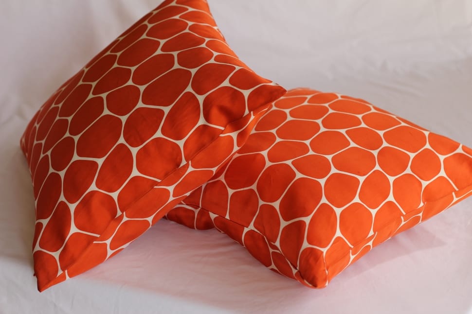 2 orange and white throw pillows preview